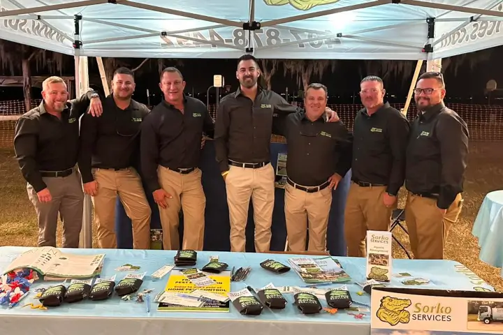 The Sorko Lawn and Pest Control team poses for a photo at an event
