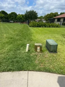 Two residential lawns side by side, where only one has received lawn care services and looks healthy by Sorko Lawn and Pest Control in Central Florida